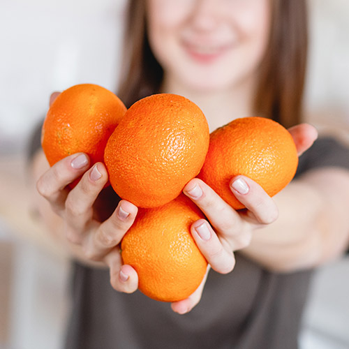 Woman holding oranges